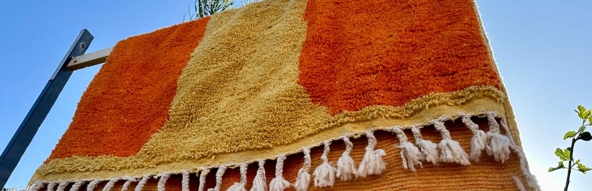 Orange and Yellow Moroccan rug airing